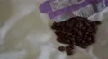 4K Chocolate raisins poured out onto white sheet and eaten 4k or 4k+ Resolution