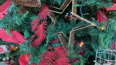 4k Christmas tree with red ribbons, lights, and ornaments close up, xmas concept Stock Footage 166785671