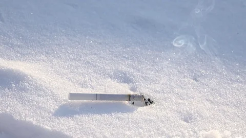 4K Cigarette burn on snow background unhealthy habit smoke pleasure winter day Stock Footage 80068743