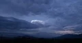 4K Cine Dusk storm clouds over mountain ridge with subtle lightning time lapse 4k or 4k+ Resolution
