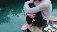 4K Cinemagraph Video Loop Of Girl Seated By A Pool. Seamless Living Photo. Stock Footage