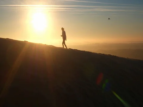 4k cinematic aerial drone shot, woman walking at beautiful sunrise, Dune du Pila Stock Footage