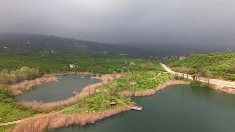 4K Cinematic Drone Flight Toward Sunlit Break in Stormy Landscape Stock-Footage 336215971