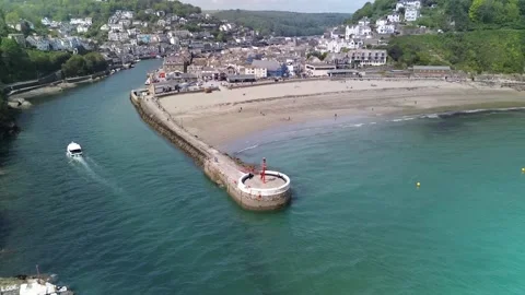 4K cinematic drone pull-back reveal of Banjo Pier and Looe Harbour Cornwall Stock Footage 334457499