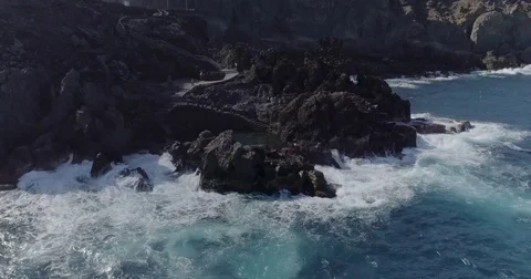 4k cinematic drone shot of powerful ocean waves crashing rocks Stock Footage 83873744