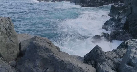 4k cinematic drone shot of powerful ocean waves crashing rocks Stock Footage 83874110