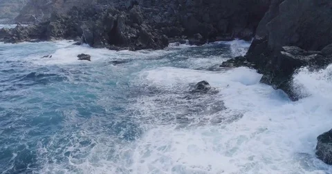 4k cinematic drone shot of powerful ocean waves crashing rocks Stock Footage 83874342