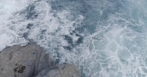 4k cinematic drone shot of powerful ocean waves crashing rocks Stock Footage 83874846