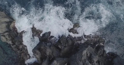 4k cinematic drone shot of powerful ocean waves crashing rocks Stock Footage 83875183