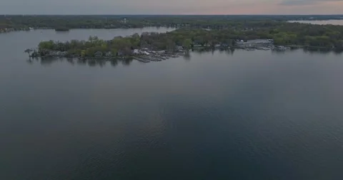 4K Cinematic Forward Aerial View of The Lost Bay Lake Minnetonka Spring Evening Stock Footage 247872928