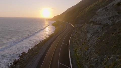 4K Cinematic Ground-Level Sunset on Iconic Pacific Coast Highway Stock Footage 316795016