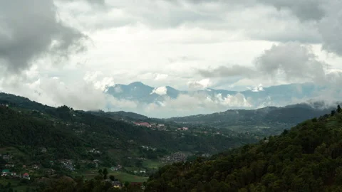4K Cinematic mountain valley time-lapse with rolling clouds over green hill Stock Footage 332483621