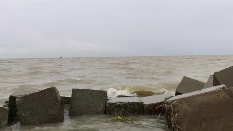 4K Cinematic Slow Right to Left Pan of River Waves and Concrete Breakwater Stock Footage 338401735