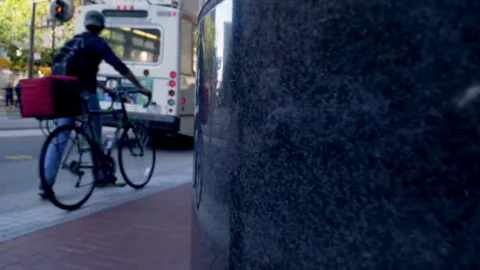 4K Cinematic Tracking Shot - Rack Focus of City Street , Bicyclist &amp; Traffic Video stock 71308500