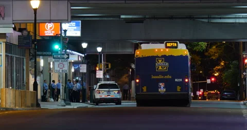 4K CITY BUS DRIVING DOWN QUIET CITY STREET UNDER BRIDGE Stock Footage 132602563