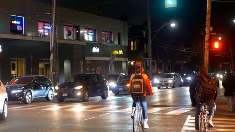 4K City Intersection Traffic, Slow Motion Cars and Cyclists Street View Night Stock Footage 83538521