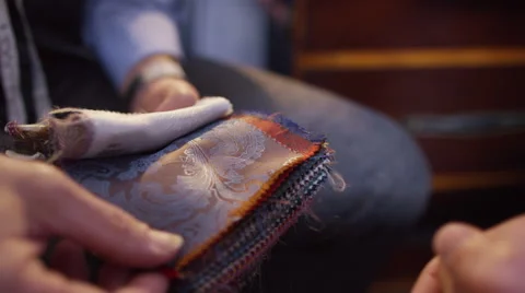 4K Client in a meeting with tailor, looking at fabrics for custom made suit Video stock 56204030