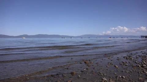 4k clip looking out over Lake Tahoe from the shore with boats and kayaks 1 Stock Footage 42896661