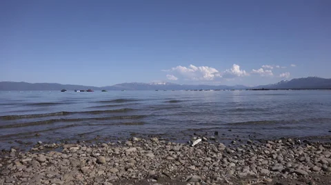 4k clip looking out over Lake Tahoe from the shore with boats and kayaks 1 Stock Footage 42897029