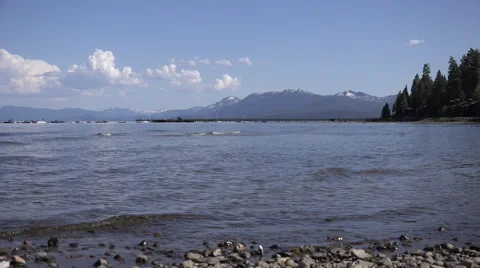 4k clip looking out over Lake Tahoe from the shore with boats and kayaks 1 Stock Footage 42897155
