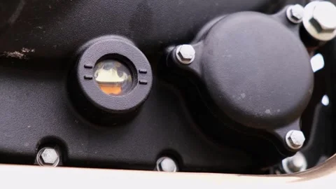4k clip with motorcycle engine oil is seen through the oil level window Video stock 242034720
