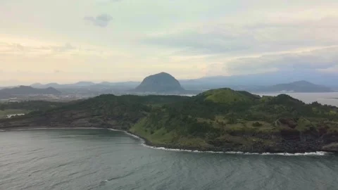 4K Clockwise Aerial Long Shot of Songaksan (송악산) Mountain, Jeju Island Stock Footage 143864157