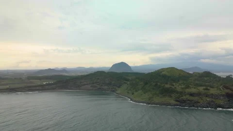 4K Clockwise Aerial Long Shot of Songaksan (송악산) Mountain, Jeju Volcanic Island Stock Footage 143864229