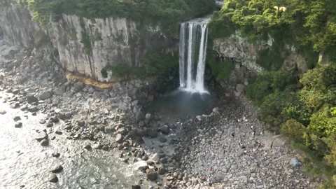 4K Clockwise High Drone View of Jeongbang Waterfall (정방폭포), Jeju Island Stock Footage 143863457