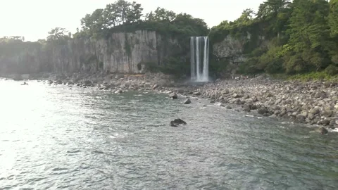 4K Clockwise Low Drone View of Jeongbang Waterfall (정방폭포), Jeju Island Stock Footage 143863440
