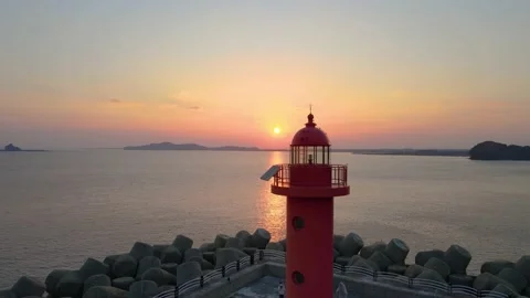 4K Close Aerial View of Sunset around a Lighthouse near Sanbangsan, Jeju Stock Footage 146068727