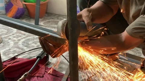 4K Close Up Angle Grinder Cutting Steel Frame with Intense Sparks Stock Footage 340465421