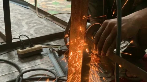 4K Close Up Angle Grinder Cutting Steel Frame with Intense Sparks Stock Footage 340465536