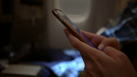 4K, Close up of asian woman using smartphone in interior of airplane. Plane-Dan Stock Footage 103042676