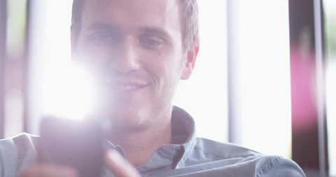 4K Close up attractive smiling man reading text or social media on smartphone Stock Footage 114752003