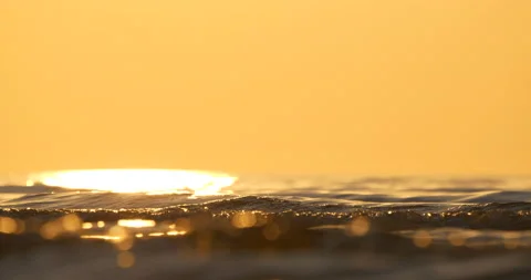 4K - Close-up background of sea waves at sunset Stock Footage 141582870