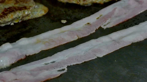 4K close up bacon cooking on a griddle Stock Footage 65509045
