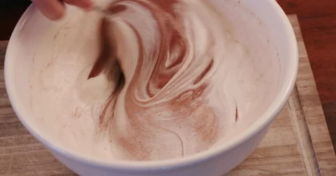 4K Close-up of blending cream into chocolate dessert Stock Footage 64694824