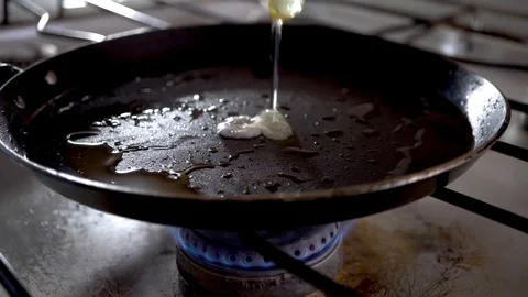  4k. Close-up of breaking and dropping one egg in a frying pan for breakfast. Stock Footage 100971683