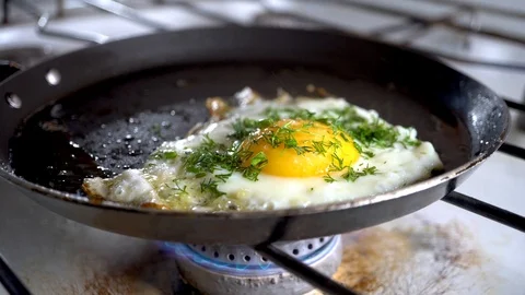  4k. Close-up of breaking and dropping one egg in a frying pan for breakfast. Stock Footage 100972605
