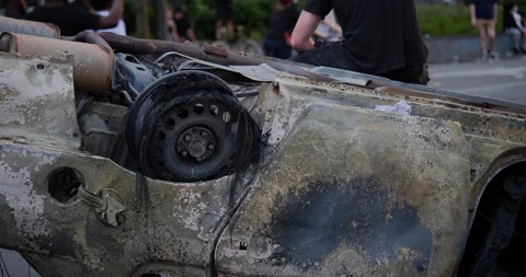 4K CLOSE UP OF A BURNED CAR THAT HAS BEEN FLIPPED OVER Stock Footage 131460302