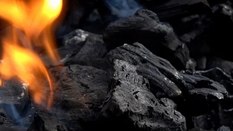 4K. Close-up of charcoal burning. Smoke and flames. Hot coal and flame. Stock Footage 101342203