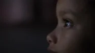 4K Close Up Of Child's Eyes Watching A Colourful Screen In The Dark Stock Footage
