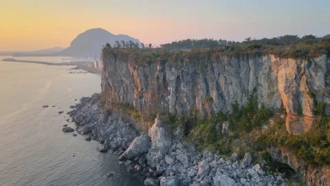 4K Close Clock-wise Aerial View of Bagsugijeong Cliff During Sunset, Jeju. Stock Footage 146068478