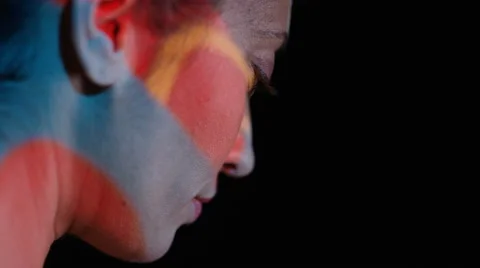 4K Close up colorful patterns of light projected onto face of attractive model Stock Footage 66587289