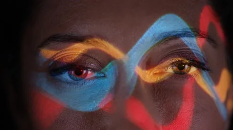 4K Close up colorful patterns of light projected onto face of attractive model Stock Footage 66589685