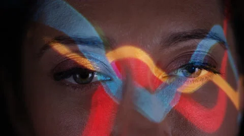 4K Close up colorful patterns of light projected onto face of attractive model Stock Footage 66591660