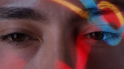 4K Close up colorful patterns of light projected onto face of attractive model Stock Footage 66595915