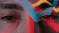 4K Close Up Colorful Patterns Of Light Projected Onto Face Of Attractive Model Stock Footage