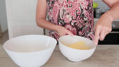 **4K Close Up of Eggs Being Whisked in White Bowl for Apple Cake** 動画素材 337742815