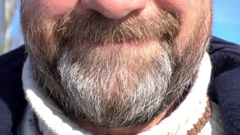 4K Close-up of a face of a bearded man expresses irritated emotions. Stock Footage 85482906